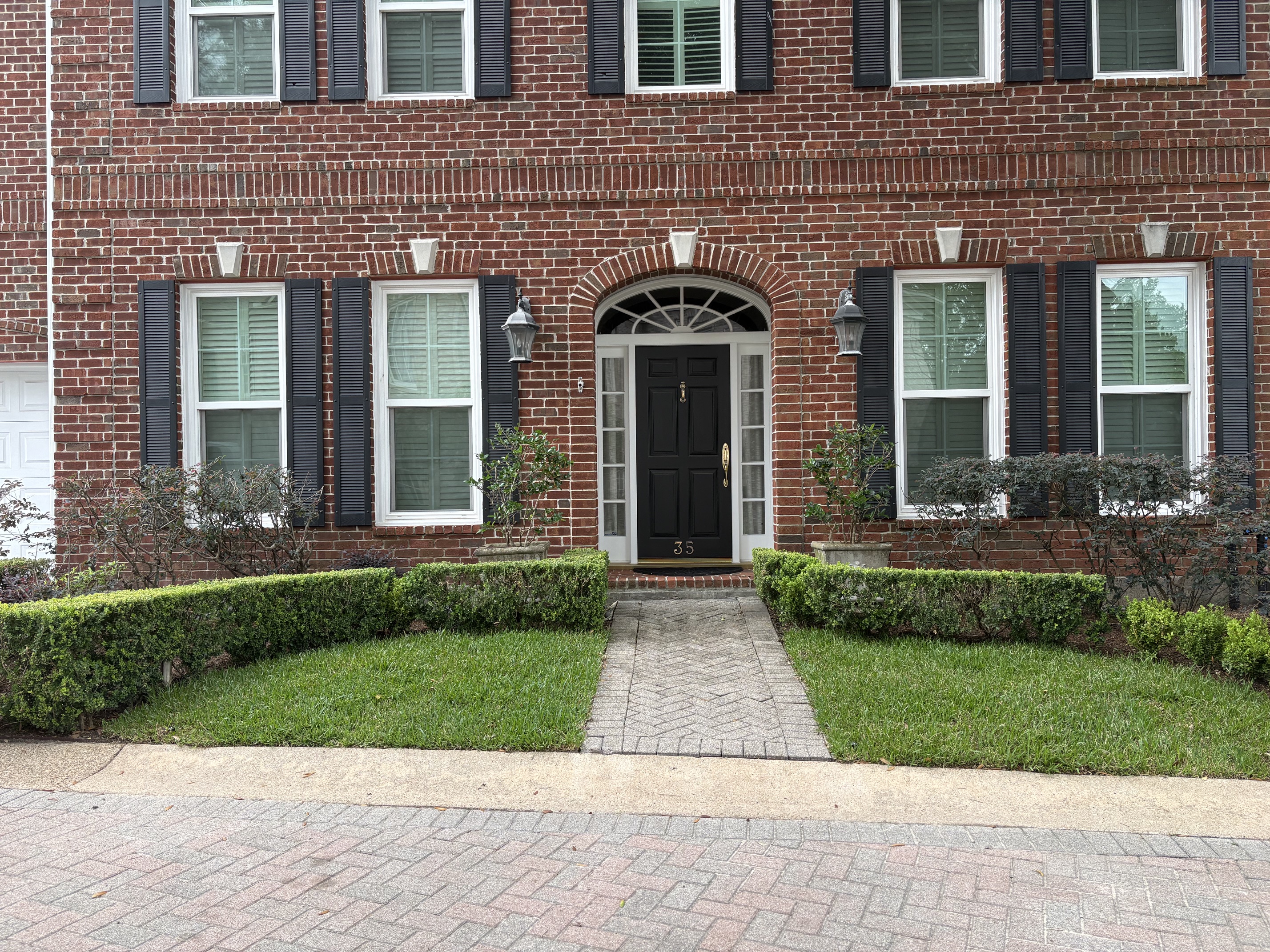 A wide view of the completed front entry, fully planted and composed after installation