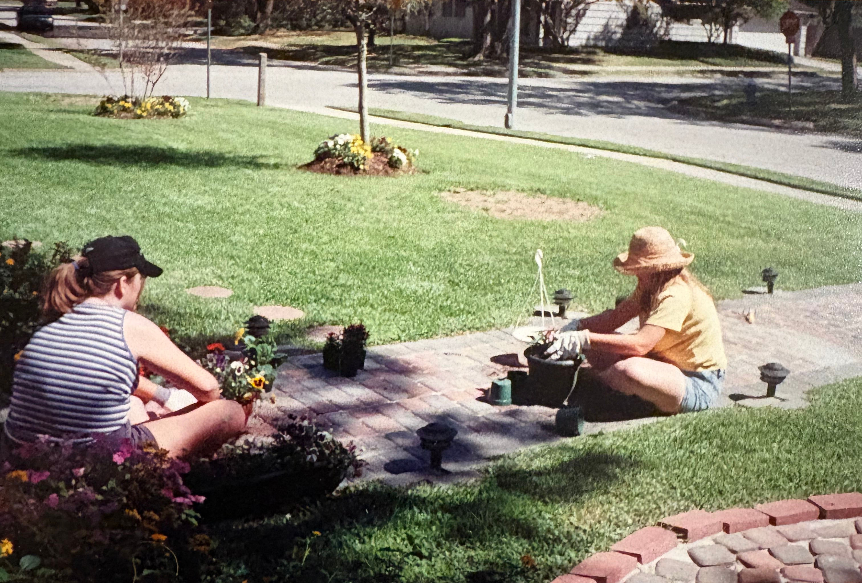 Katherine as a teenager with her sister, working the front-yard beds